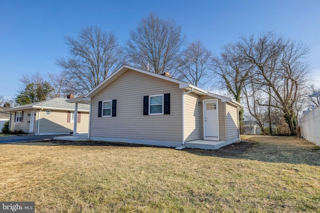 view of front of property with a front yard and fence