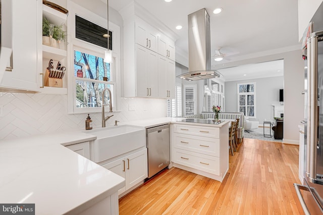 kitchen with white cabinetry, a peninsula, island exhaust hood, a sink, and dishwasher