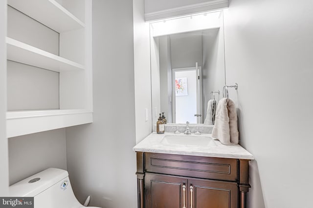 bathroom featuring toilet and vanity