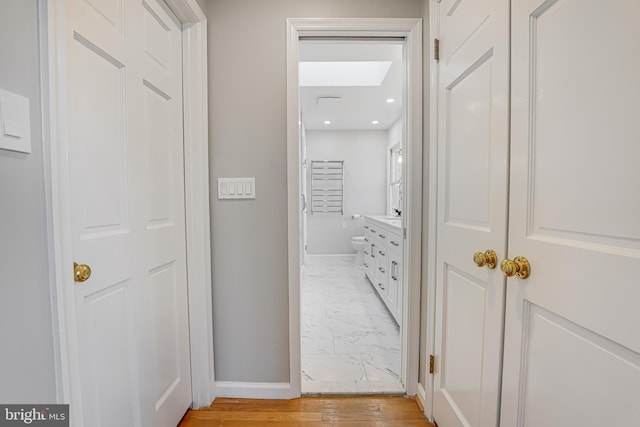 hallway featuring recessed lighting, baseboards, and marble finish floor