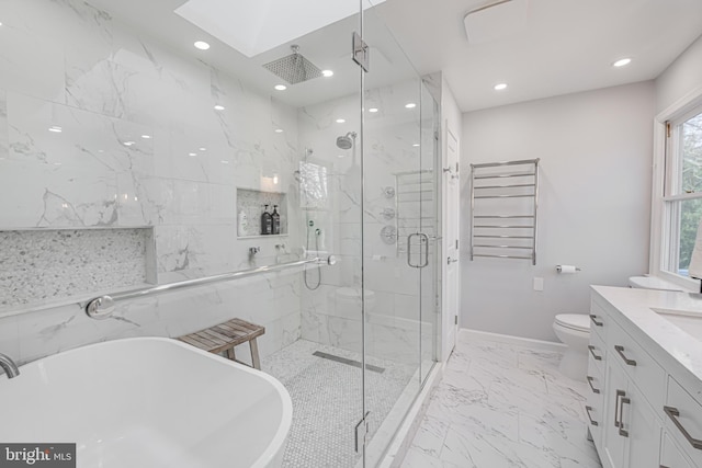 bathroom featuring a marble finish shower, a skylight, radiator heating unit, a freestanding bath, and marble finish floor