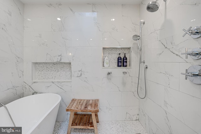 full bathroom with a freestanding tub and tiled shower