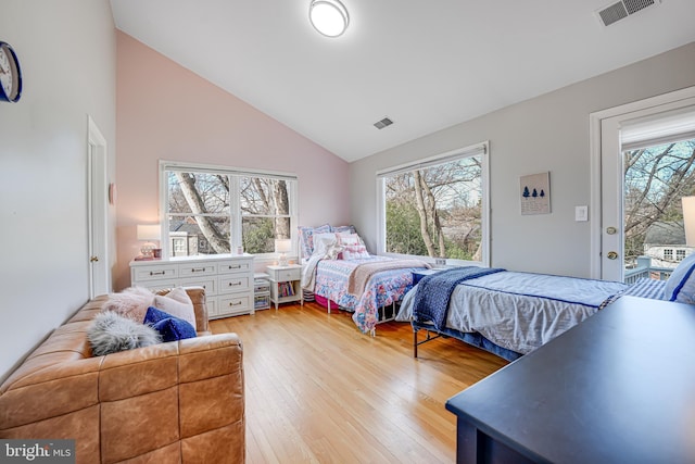 bedroom featuring access to outside, light wood-style flooring, multiple windows, and visible vents