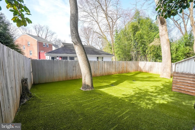 view of yard with a fenced backyard