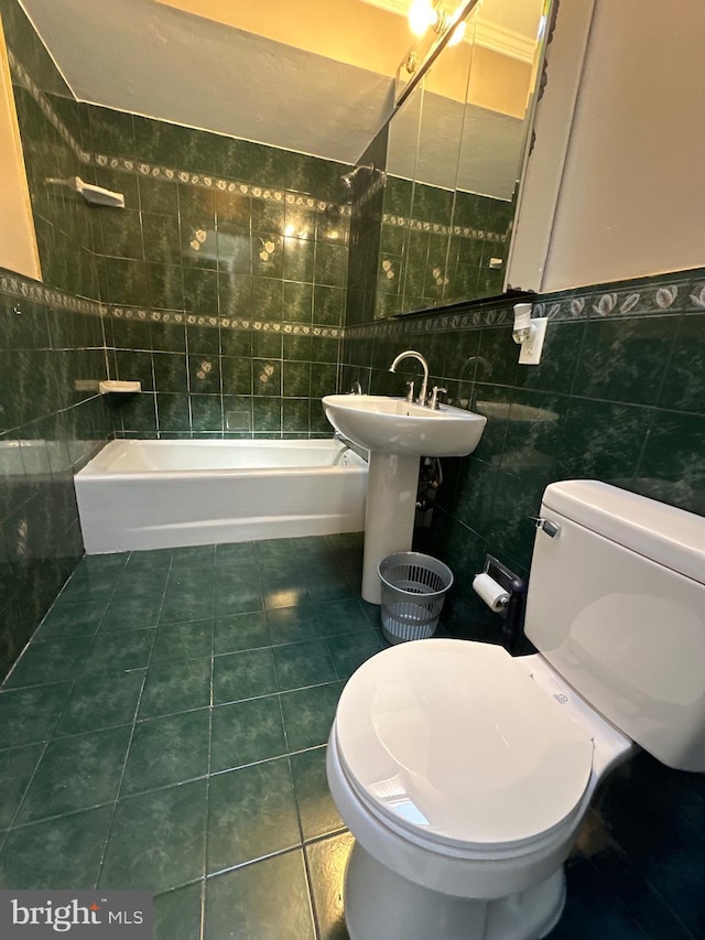 bathroom featuring tile patterned floors, toilet, tile walls, and bathtub / shower combination