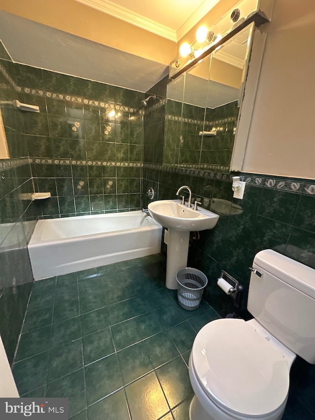 full bath with tub / shower combination, ornamental molding, tile patterned flooring, tile walls, and toilet