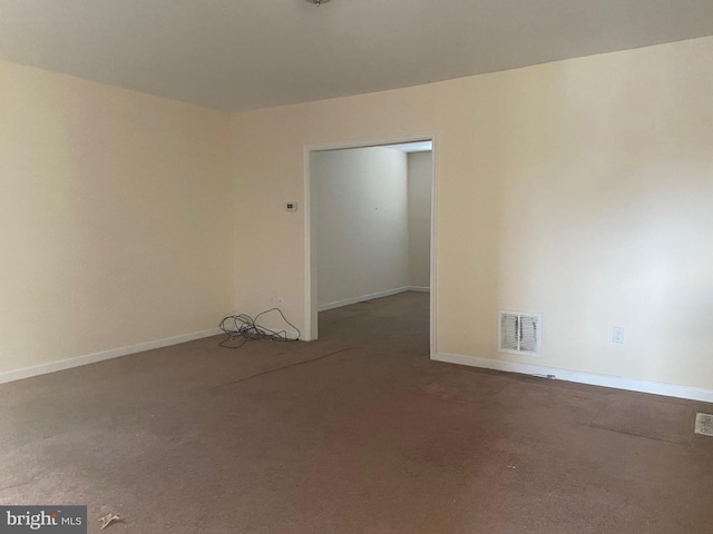 unfurnished room with visible vents and baseboards