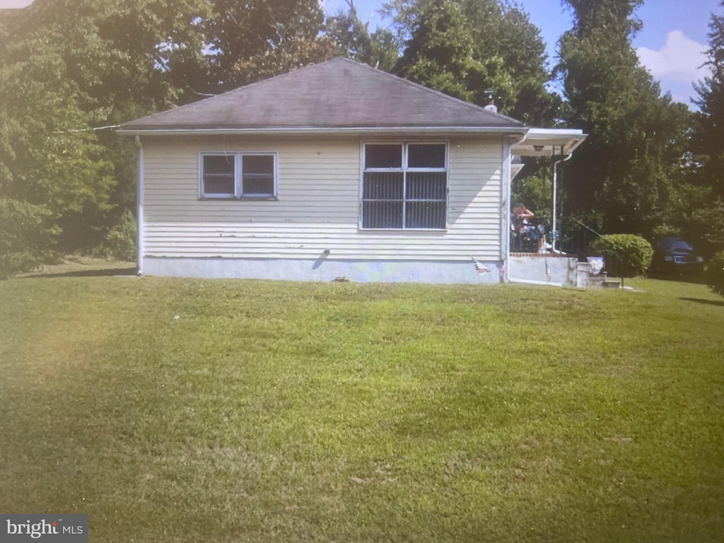 view of property exterior featuring a lawn