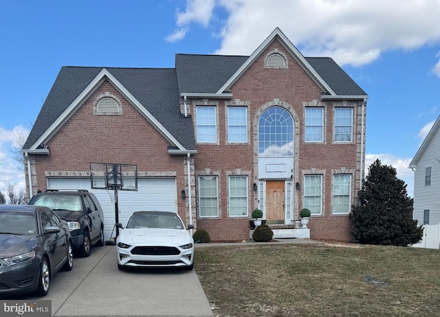 view of front of home featuring a front lawn, brick siding, roof with shingles, and driveway