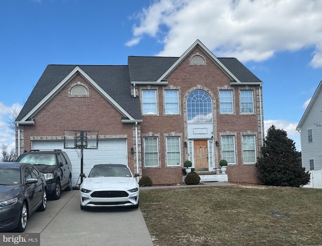 view of front facade with a garage, brick siding, and driveway