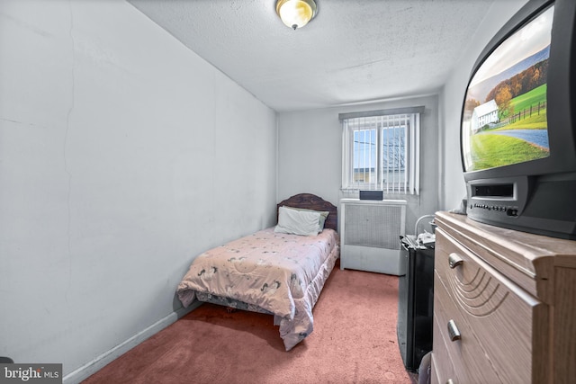 bedroom with carpet flooring, baseboards, and a textured ceiling