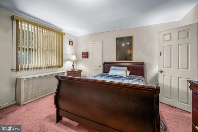 bedroom featuring radiator and carpet flooring