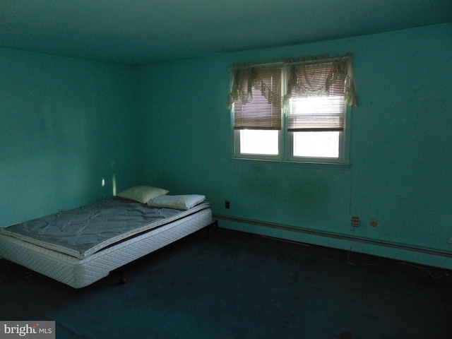 unfurnished bedroom featuring carpet and a baseboard radiator