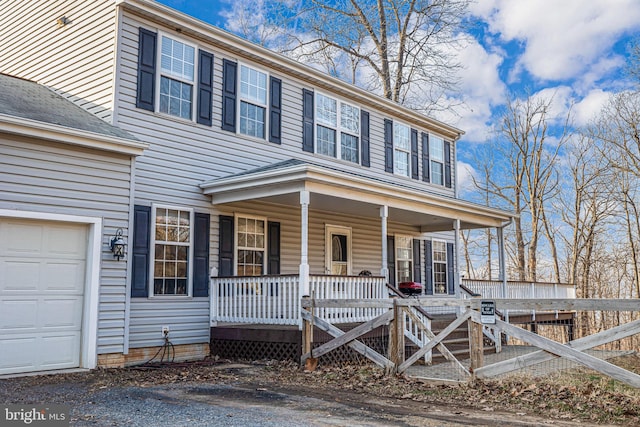 view of front facade with a garage and covered porch