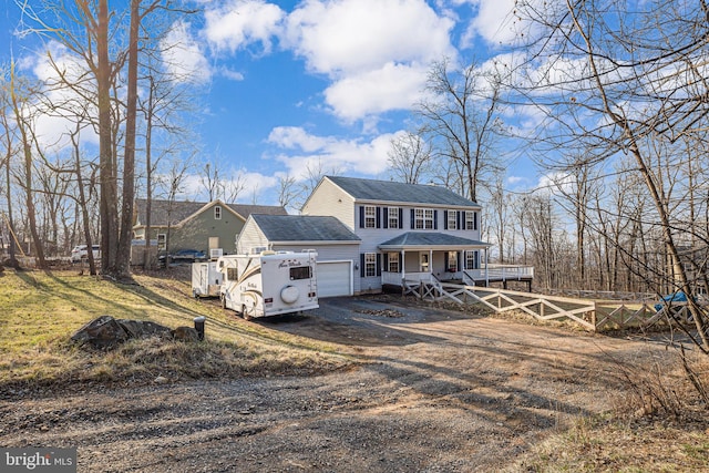 view of front of home featuring an attached garage, fence, roof with shingles, covered porch, and driveway