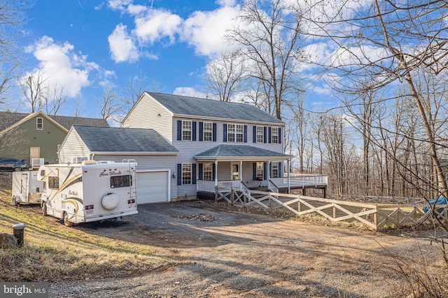 view of front of house with a shingled roof, fence, dirt driveway, a porch, and a garage