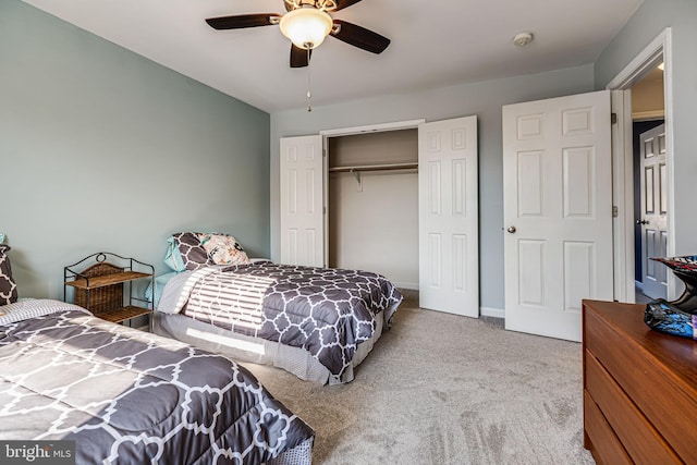 bedroom with a closet, carpet flooring, baseboards, and a ceiling fan