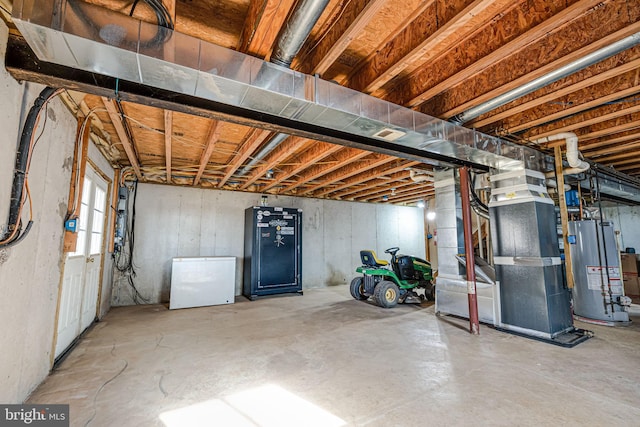 below grade area featuring heating unit, gas water heater, and fridge