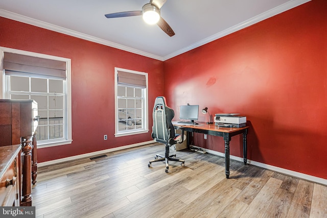 office featuring wood finished floors, baseboards, a ceiling fan, visible vents, and ornamental molding