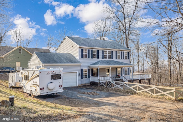 view of front of property with a shingled roof, fence, a porch, a garage, and driveway