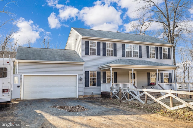 colonial-style house with a porch, driveway, and an attached garage