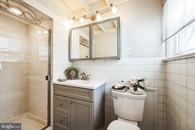 bathroom featuring vanity, tile walls, toilet, and a stall shower