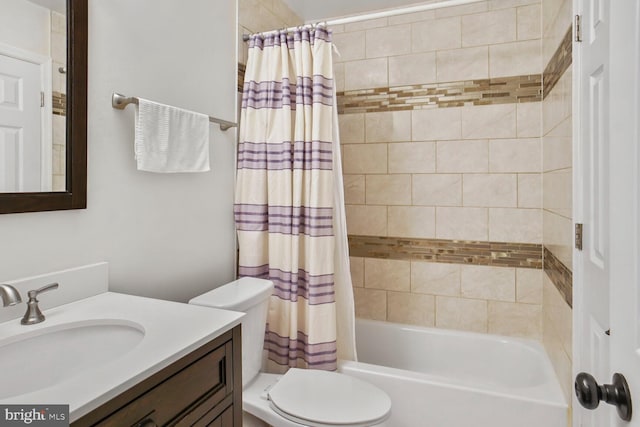 full bath with toilet, shower / bath combo, and vanity