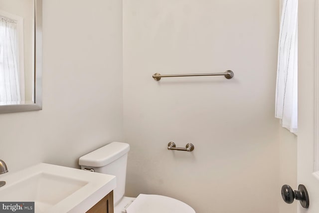 bathroom featuring toilet and vanity
