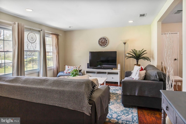 living area with visible vents, recessed lighting, and dark wood finished floors