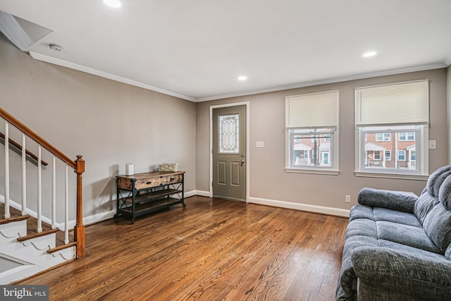 foyer entrance featuring crown molding, baseboards, stairs, hardwood / wood-style floors, and recessed lighting