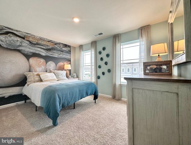 bedroom with carpet flooring, visible vents, and baseboards