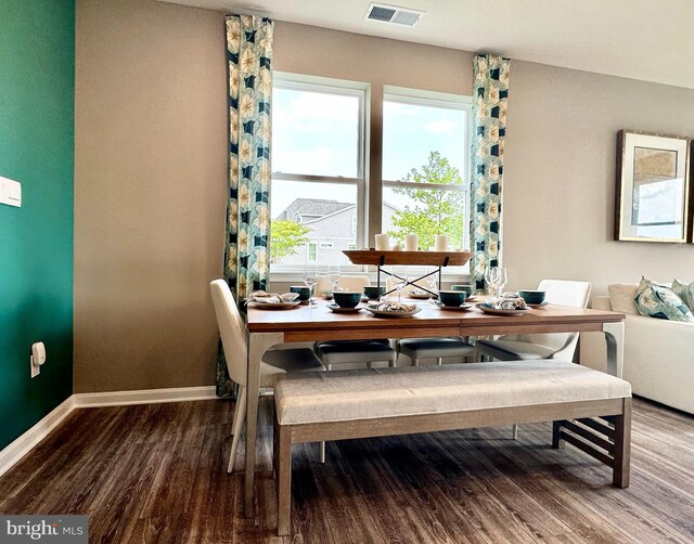 dining room with visible vents, baseboards, and wood finished floors