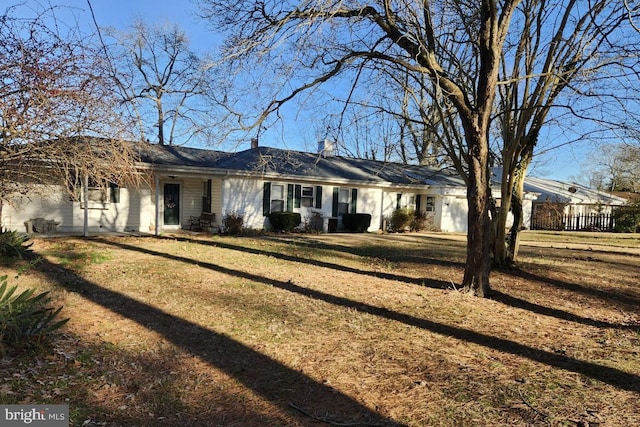 view of front facade featuring a front yard and a chimney