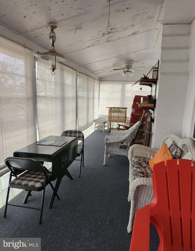 sunroom featuring ceiling fan