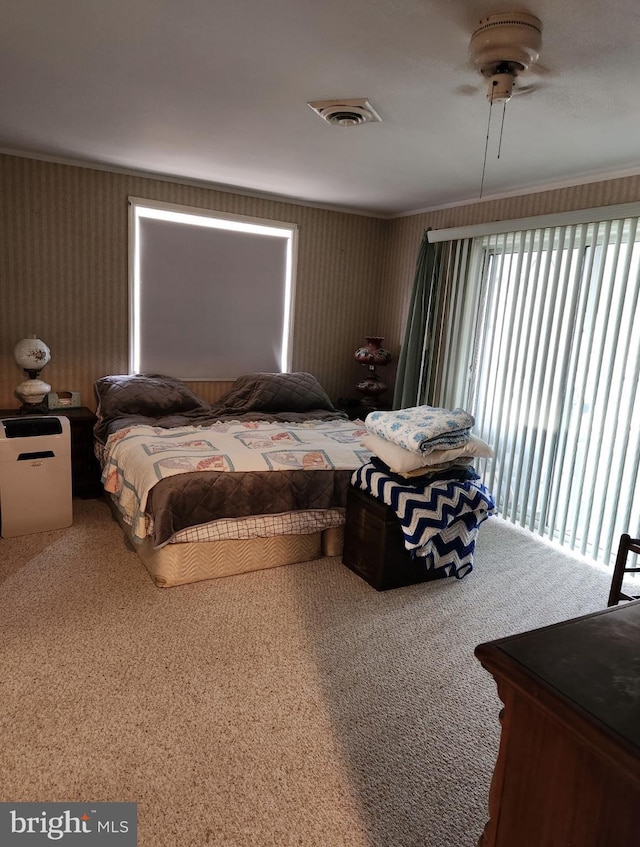 bedroom with visible vents and crown molding