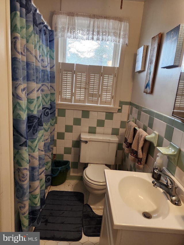 full bath featuring a shower with curtain, toilet, tile walls, tile patterned flooring, and vanity