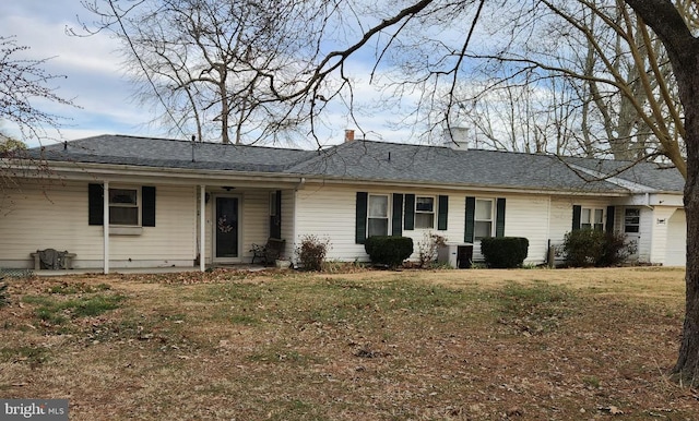 ranch-style home with a front lawn and a chimney