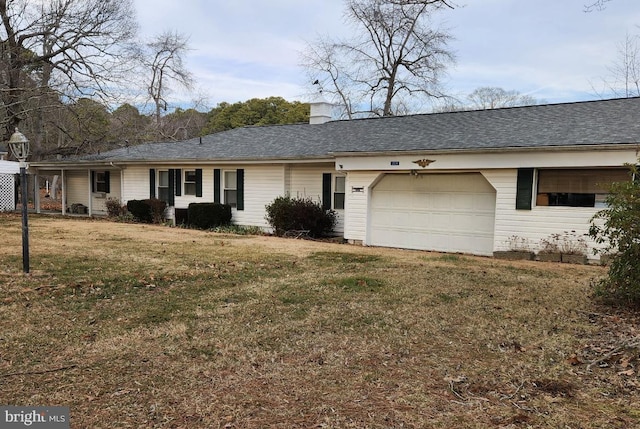 view of front facade featuring a garage, a chimney, a front lawn, and a shingled roof