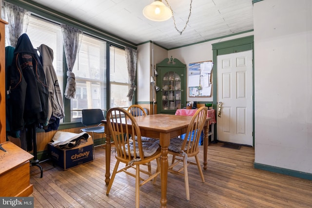 dining area with hardwood / wood-style flooring, baseboards, and visible vents