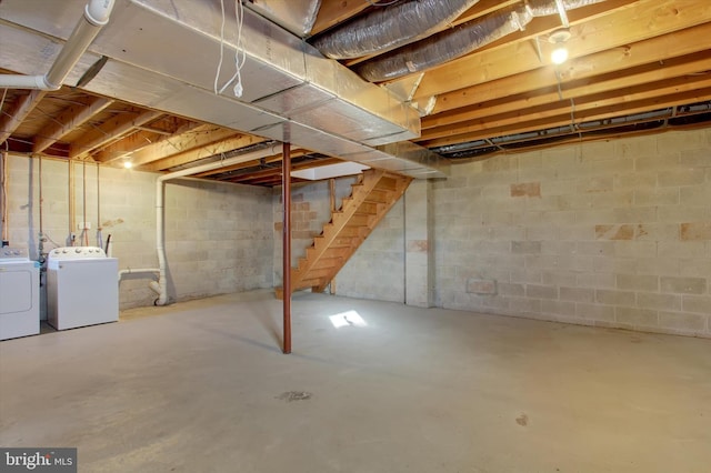 unfinished basement featuring washing machine and clothes dryer and stairs