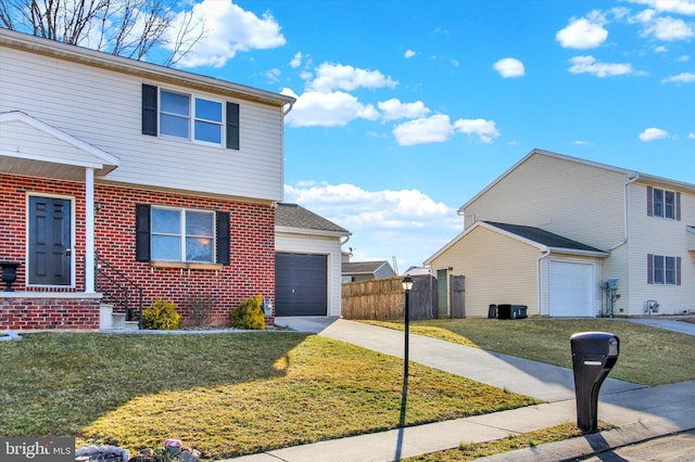 view of front of property featuring fence, concrete driveway, a front yard, an attached garage, and brick siding