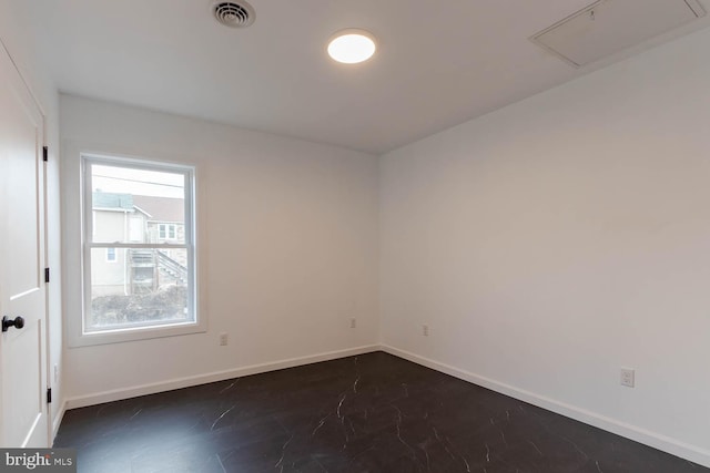 unfurnished room with visible vents and baseboards