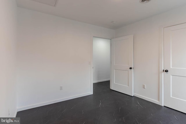 unfurnished bedroom featuring visible vents and baseboards