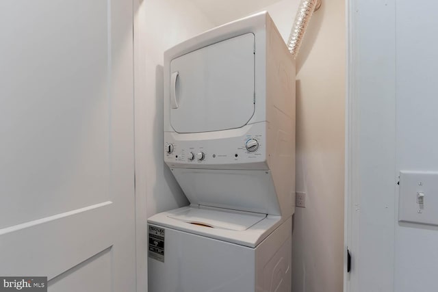 clothes washing area featuring laundry area and stacked washer and dryer