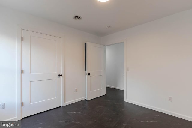 unfurnished bedroom with visible vents and baseboards