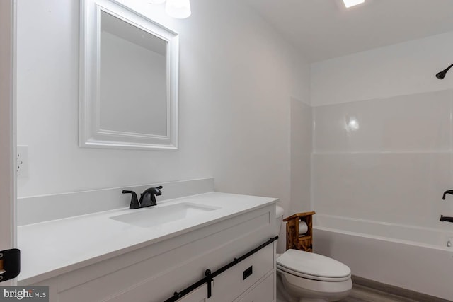 bathroom featuring vanity, bathing tub / shower combination, and toilet