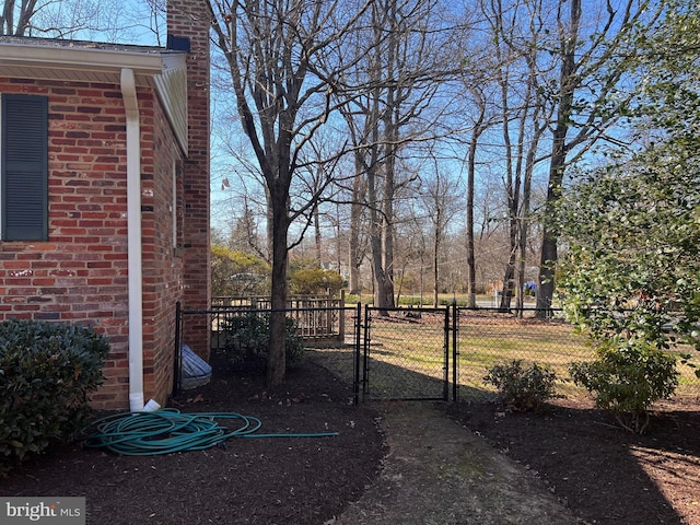 view of yard featuring fence and a gate