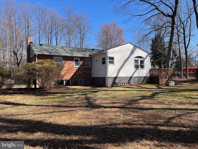 back of property with a yard and a chimney