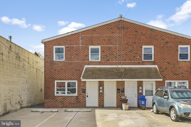 exterior space with brick siding and fence