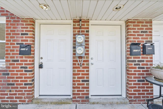 doorway to property with brick siding